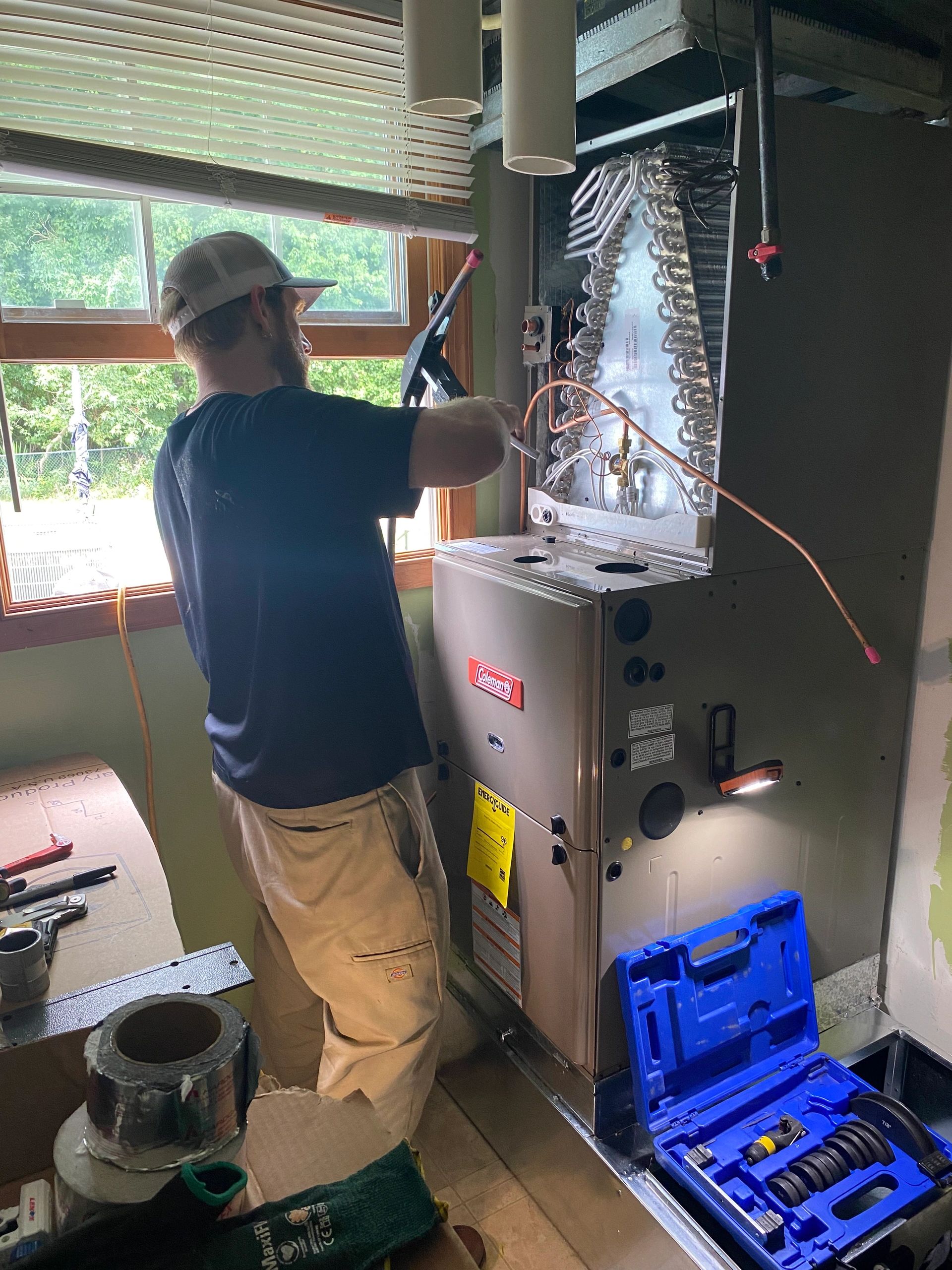 Technician servicing furnace